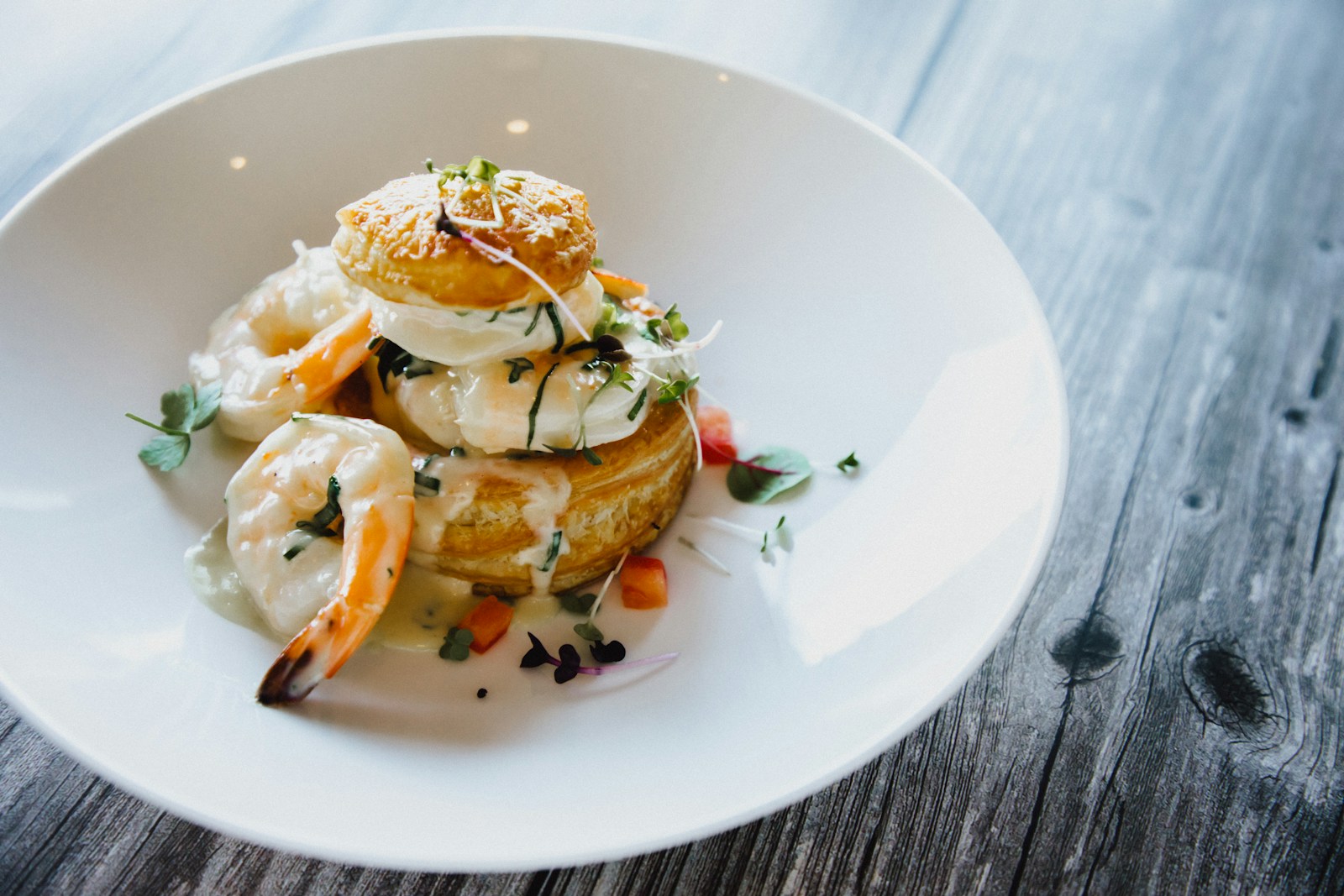 a white plate topped with food on top of a wooden table