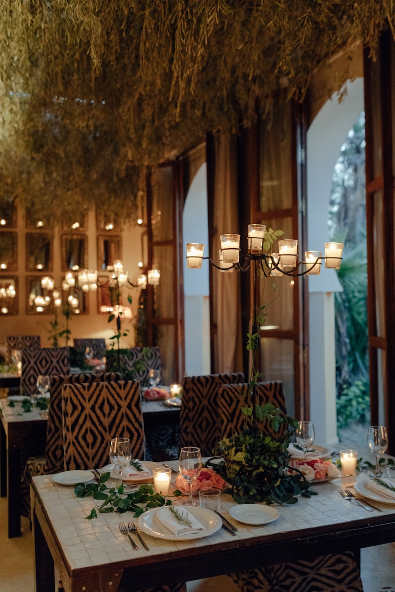 a table with plates and candles in a restaurant